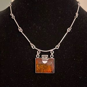 Custom made necklace made out of sterling silver and amber.